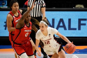 Stanford guard Lexie Hull drives past Arizona forward Trinity Baptiste during the first half of the women's NCAA championship game at the Alamodome in San Antonio, Texas, on April 4, 2021. Credit: © Morry Gash, AP/Shutterstock