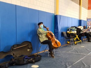 Famed cellist Yo-Yo Ma performs for people waiting in line at a COVID-19 vaccination site at Berkshire Community College in Pittsfield, Massachusetts, on March 13, 2021. Credit: © Berkshire Community College