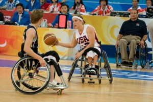 Two women's teams face each other in a basketball game during the Summer Paralympic Games. The Paralympics game follows the basic rules of regular basketball but with the players competing in wheelchairs. © Bob Daemmrich, Alamy Images