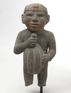 An Aztec sculpture found in Amatlan, Mexico, shows a man holding a cacao pod. The Aztec people ruled an empire in Mexico in the 1400's and early 1500's. Museum Collection Fund, Brooklyn Museum