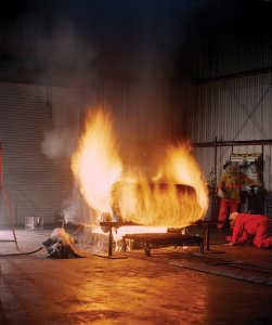 A flammability test determines how fast a substance burns. These scientists are observing how a car's plastic fuel tank holds up during a fire. © Southwest Research Institute