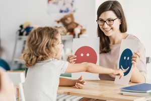 Therapist working with a child with autism spectrum disorder (ASD)