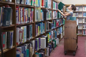 The organization of materials is one of the central tasks of a librarian's work. This library worker is shelving books according to call numbers, which reflect the subject matter of the books. Credit: © Blend Images/SuperStock