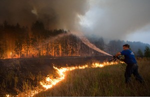 A Russian firefighter sprays water on a wildfire in the Ryazan region, southeast of Moscow. In 2010, a devastating wave of wildfires wept across Russia following a record-setting heat wave. Credit: AP Photo