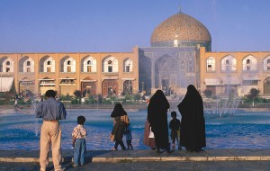 In the Middle East, Islam is the dominant religion. Islam's followers, Muslims, worship in mosques, like the one in Iran shown here. The women in the foreground have their heads covered, as required by Islamic law in Iran. In most other countries, Muslim women can choose whether to wear a veil or head cover. Credit: © Patrick Ben Luke Syder, Lonely Planet Images