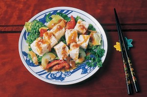 Tofu is a food made of soybean curds pressed into cakes or blocks. Chunks of tofu can be prepared in many ways and added to many dishes, including salads, shown here. Credit: © Cathy Melloan