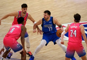 Dallas Mavericks guard Luka Dončić protects the basketball in a game against the Washington Wizards. Credit: © Tony Quinn, Sipa USA/Alamy Images