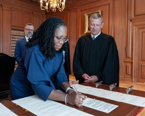 Justice Ketanji Brown Jackson signs an oath of office on June 30, 2022, as she is sworn in as the first Black woman to serve on the Supreme Court. Credit: US Supreme Court