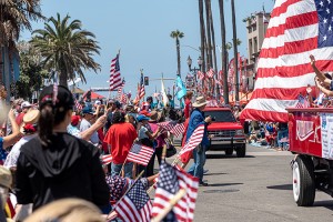 People gather at a Fourth of July parade in Huntington Beach, California, in 2019. Credit: © Sal Augruso, Shutterstock